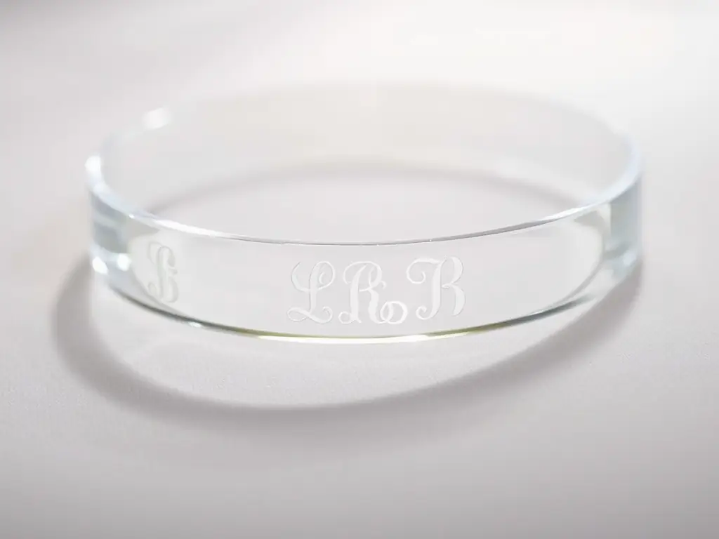 Close-up of a personalized crystal gift with engraved initials.